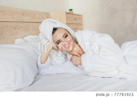 Beautiful young healthy woman relaxing in a robe, hotes, room, spa salon Beautiful young healthy woman relaxing in a robe, hotes, room, spa salon 77761923