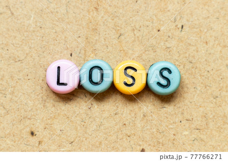 Round color bead with black letter in word loss on wood background Round color bead with black letter in word loss on wood background 77766271