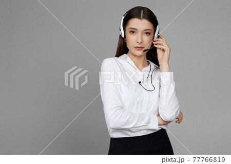 caucasian woman with headset on gray background caucasian woman with headset on gray background 77766819