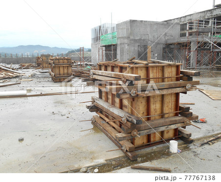 KUALA LUMPUR, MALAYSIA -SEPTEMBER 19, 2016: Column timber form work and reinforcement bar at the construction site. The structure supported by temporary wood support 77767138
