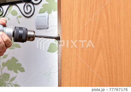 Locksmith use a flat bit to wood when drilling a hole for latch. 77767176