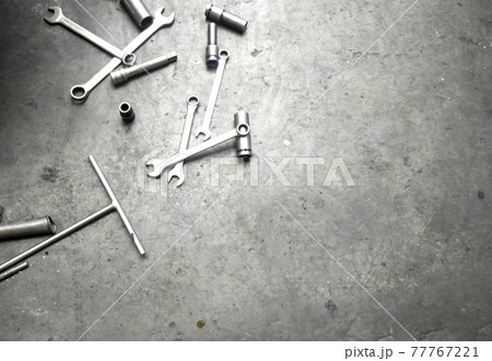 SELANGOR, MALAYSIA -APRIL 16, 2017: Car workshop tools left lying around on the floor. Workshop floor greasy and dirty. SELANGOR, MALAYSIA -APRIL 16, 2017: Car workshop tools left lying around on the floor. Workshop floor greasy and dirty. 77767221