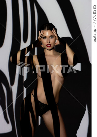 Fashion portrait of young lady with shadow on her body 77768585