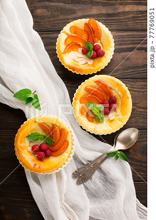 Homemade Autumn Tartlets with cottage cheese and fresh fruits on rustic wooden table. Homemade Autumn Tartlets with cottage cheese and fresh fruits on rustic wooden table. 77769051