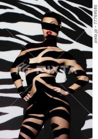 Fashion portrait of young lady with shadow on her body 77769080