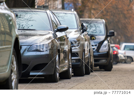 Cars parked in a row on a city street side. Cars parked in a row on a city street side. 77771014