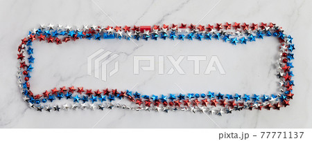 American Independence Day red blue white stars beads frame on on Marble Background. USA flag colors stylish fourth of july wallpaper. American Independence Day red blue white stars beads frame on on Marble Background. USA flag colors stylish fourth of july wallpaper. 77771137