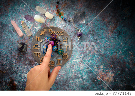zodiac horoscope symbol with fortune-teller hands and healing crystals on rustic background zodiac horoscope symbol with fortune-teller hands and healing crystals on rustic background 77771145