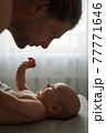 Crop father looking at cute baby at home 77771646