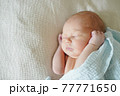 Adorable baby sleeping on bed at home 77771650