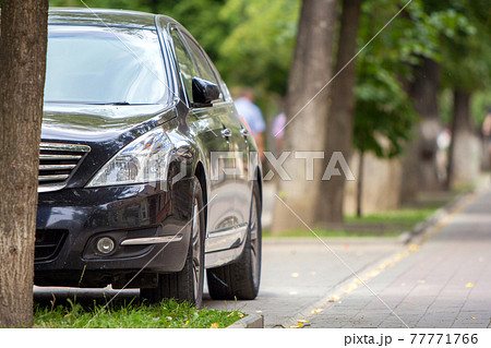 A car parked near curb on the side of the street on a parking lot. 77771766
