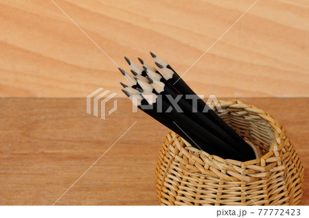 Pencils tied with a rope of straw and place in a container that is made from woven rattan. Pencils tied with a rope of straw and place in a container that is made from woven rattan. 77772423