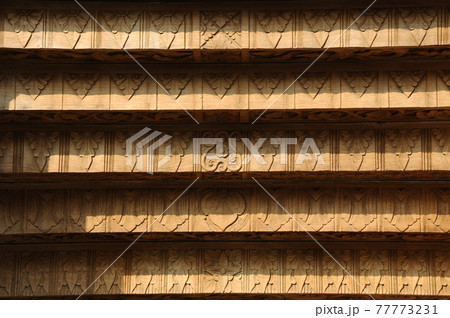 JOGJAKARTA, INDONESIA -JUNE 12, 2014: Wood carving detail with floral & arabic word at old Mosque of Masjid Besar Mataram Kotagede. Build on 1575. JOGJAKARTA, INDONESIA -JUNE 12, 2014: Wood carving detail with floral & arabic word at old Mosque of Masjid Besar Mataram Kotagede. Build on 1575. 77773231