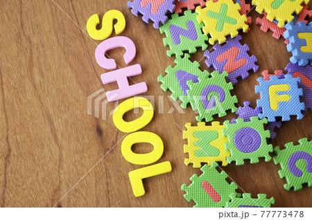 SCHOOL conceptual word made from rubber foam and colorful rubber puzzle alphabet randomly arrange. Isolated on wood texture background. SCHOOL conceptual word made from rubber foam and colorful rubber puzzle alphabet randomly arrange. Isolated on wood texture background. 77773478