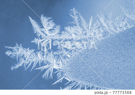 frosty patterns on the window glass closeup. natural textures and backgrounds 77773568