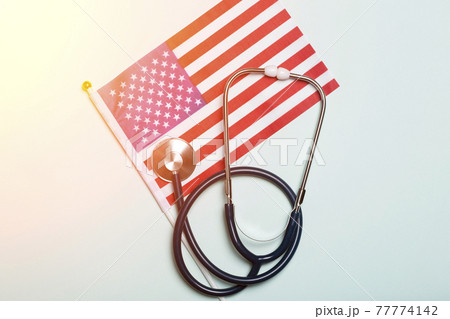 USA medicine background. Stethoscope on the American flag. Healthcare and medical services in the USA concept. 77774142