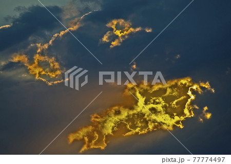 brightly contrasting cloudy sky at sunset 77774497