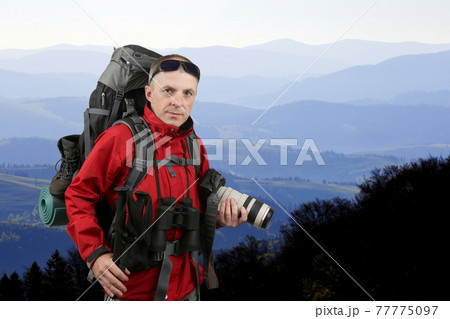 the equipped with the traveler photographer in the red jacket 77775097