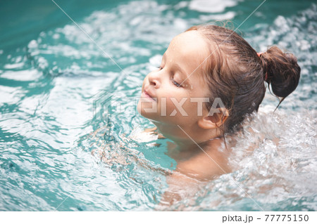 Pretty little girl in swimming pool Pretty little girl in swimming pool 77775150