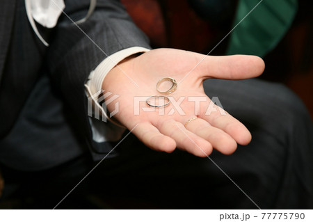 gold rings for wedding are on the palm of the groom gold rings for wedding are on the palm of the groom 77775790