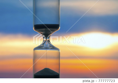 Hourglass on the background of a sunset. The value of time in life. An eternity.. 77777723