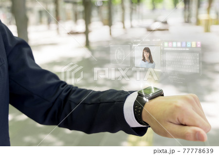 次世代スマートウオッチ(イメージ)を使うビジネスマン　ホログラム 77778639