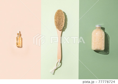 Body treatment and spa composition. Flat lay with natural beauty products. Bath salt, serum bottle. Brush for dry anti-cellulite massage. Dropper glass Oily cosmetic pipette Body treatment and spa composition. Flat lay with natural beauty products. Bath salt, serum bottle. Brush for dry anti-cellulite massage. Dropper glass Oily cosmetic pipette 77778724