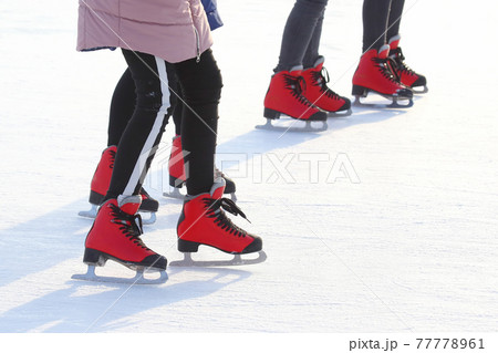 Feet of people skating on a street ice rink Feet of people skating on a street ice rink 77778961