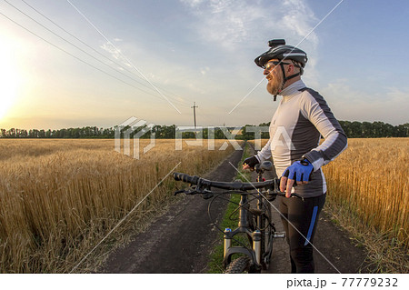 cyclist on Bicycle looks at sunset. sports and hobbies. outdoor activities cyclist on Bicycle looks at sunset. sports and hobbies. outdoor activities 77779232