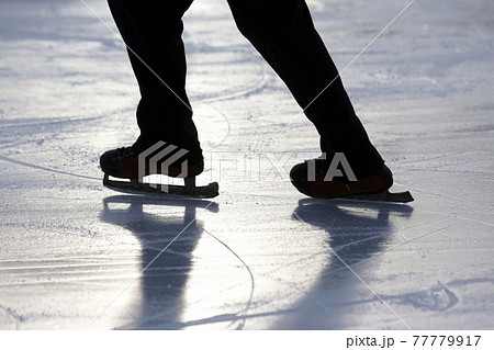 silhouette foot ice-skating person on the ice rink. silhouette foot ice-skating person on the ice rink. 77779917