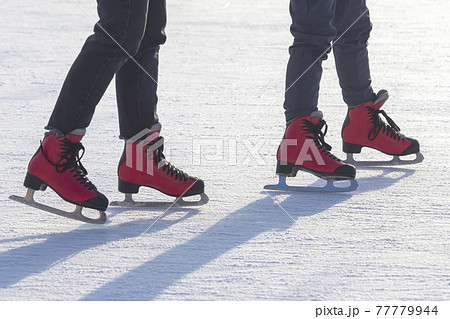 different people are actively skating on an ice rink. hobbies and leisure. winter sports different people are actively skating on an ice rink. hobbies and leisure. winter sports 77779944