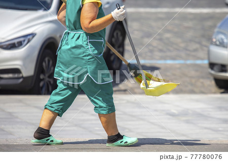 janitor cleans the sidewalk of the city janitor cleans the sidewalk of the city 77780076