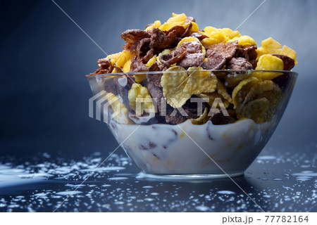 bowl of cornflakes filled with milk 77782164