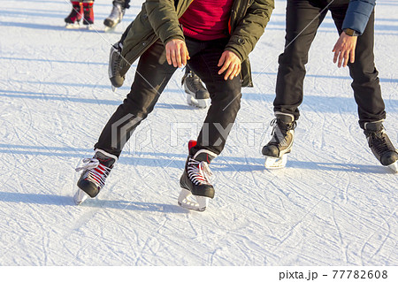 people ice skating on an ice rink. hobbies and leisure. winter sports people ice skating on an ice rink. hobbies and leisure. winter sports 77782608