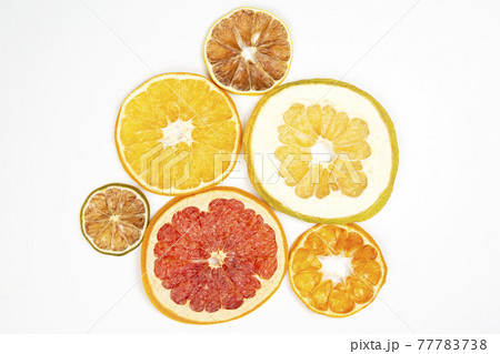 Dried slices of various citrus fruits on white background Dried slices of various citrus fruits on white background 77783738