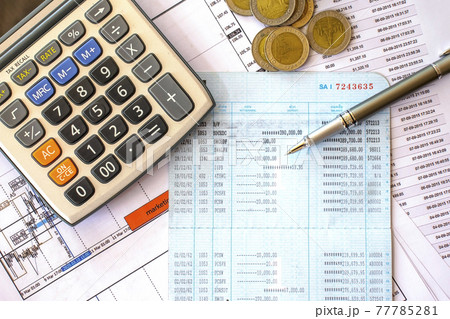Pens and coins in the pockets on financial documents, financial concepts, tax calculations and financial status checking concepts. 77785281