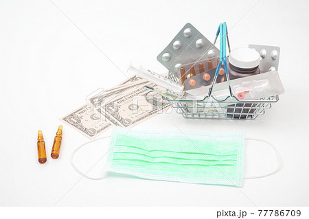 pills, ampoules and syringe for injection and money dollars on a white background 77786709