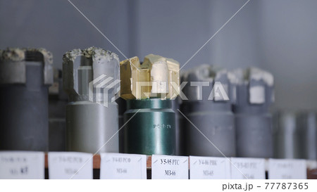 New Drill Bits on shelving in stock. Oil drilling equipment for drilling rig operation on oil platform in oil and gas industry. Brand new PDC Polycrystalline Diamond Compact drilling bit 77787365