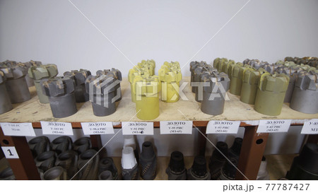 Drill Bits on shelving in stock. Oil drilling equipment for drilling rig operation on oil platform in oil and gas industry. Brand new PDC Polycrystalline Diamond Compact drilling bit 77787427