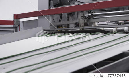 Enterprise for the production of cardboard containers .Cardboard manufacturing layering rollers roll industrial industry printing packaging material closeup. Paper corrugated box factory. Enterprise for the production of cardboard containers .Cardboard manufacturing layering rollers roll industrial industry printing packaging material closeup. Paper corrugated box factory. 77787453
