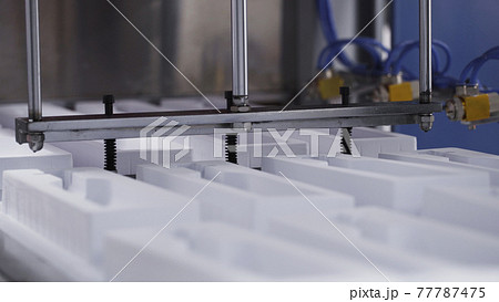Create plastic package and packing. Machines create packing for bottles. Process of manufacturing plastic containers on extrusion equipment-moving molds and manipulator takes finished product Create plastic package and packing. Machines create packing for bottles. Process of manufacturing plastic containers on extrusion equipment-moving molds and manipulator takes finished product 77787475