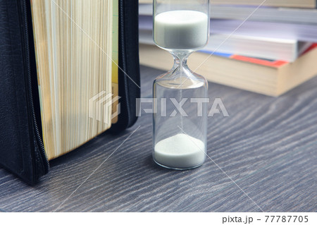 hourglass and bible with. sow the seed of faith in God. Christianity and religion 77787705