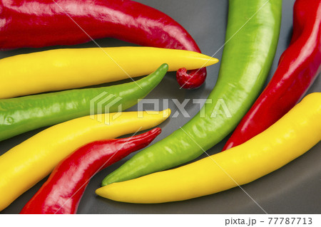 yellow, red and green hot chili on a plate. Pepper. Vegetable vitamin food. yellow, red and green hot chili on a plate. Pepper. Vegetable vitamin food. 77787713