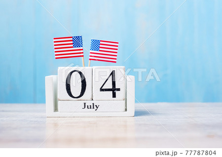 Wooden calendar of July 4th with miniature United States of America flag on wood background. Independence day and nation Holiday concept 77787804