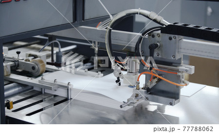 Modern automatic conveyor line for the production of package. Modern factory of production cardboard box. Manufacture of cardboard boxes from paper. Enterprise for production package Modern automatic conveyor line for the production of package. Modern factory of production cardboard box. Manufacture of cardboard boxes from paper. Enterprise for production package 77788062
