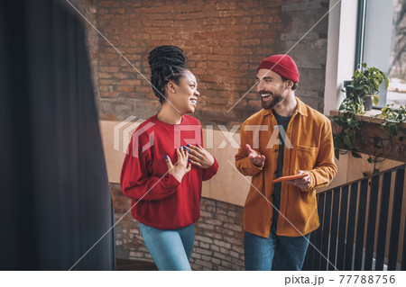 Young man and a woman talking and looking interested 77788756