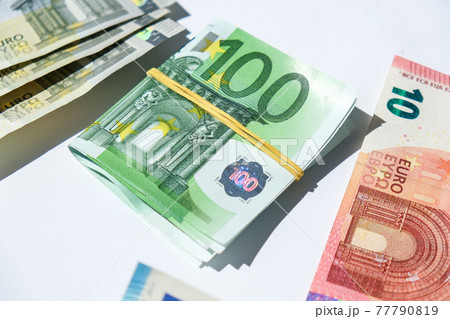 Close up of Euro money roll. Euro banknote set cash money - EU currency. Rolled with rubber euro notes. Banknotes stacked on each other in different positions 77790819