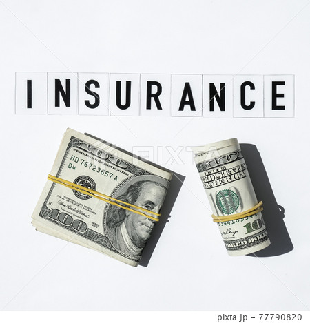 Text INSURANCE around US dollar banknotes. Health, life, home, car Insurance. Insurance business concept. Health care or medicare insurance and vaccination costs. Financial crisis. Covid-19 crimes 77790820