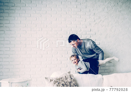 loving father plays with his baby daughter 77792028