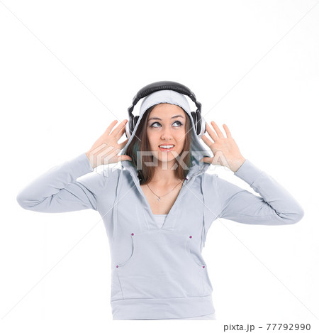 young woman listening to music with headphones young woman listening to music with headphones 77792990
